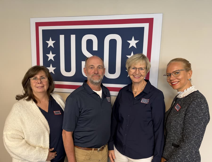 The four board members of USO Deutschland e.V. standing together in front of a USO logo.